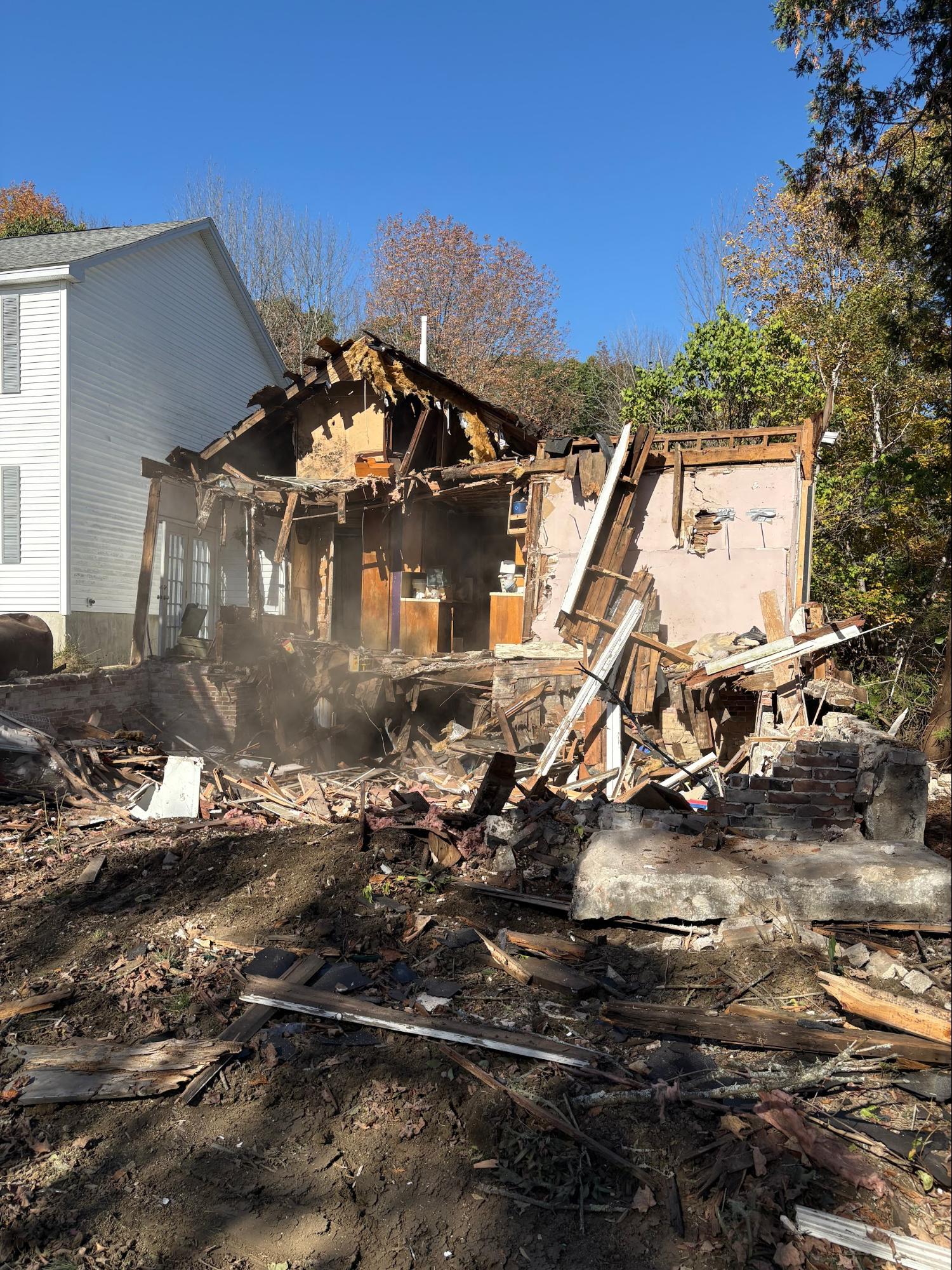 House mid-demolition with debris