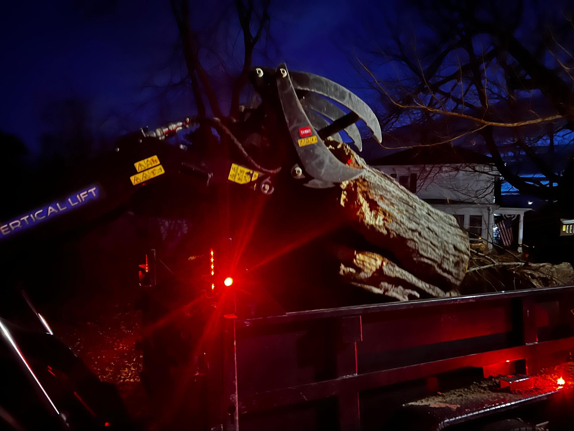 Night tree removal with grapple attachment