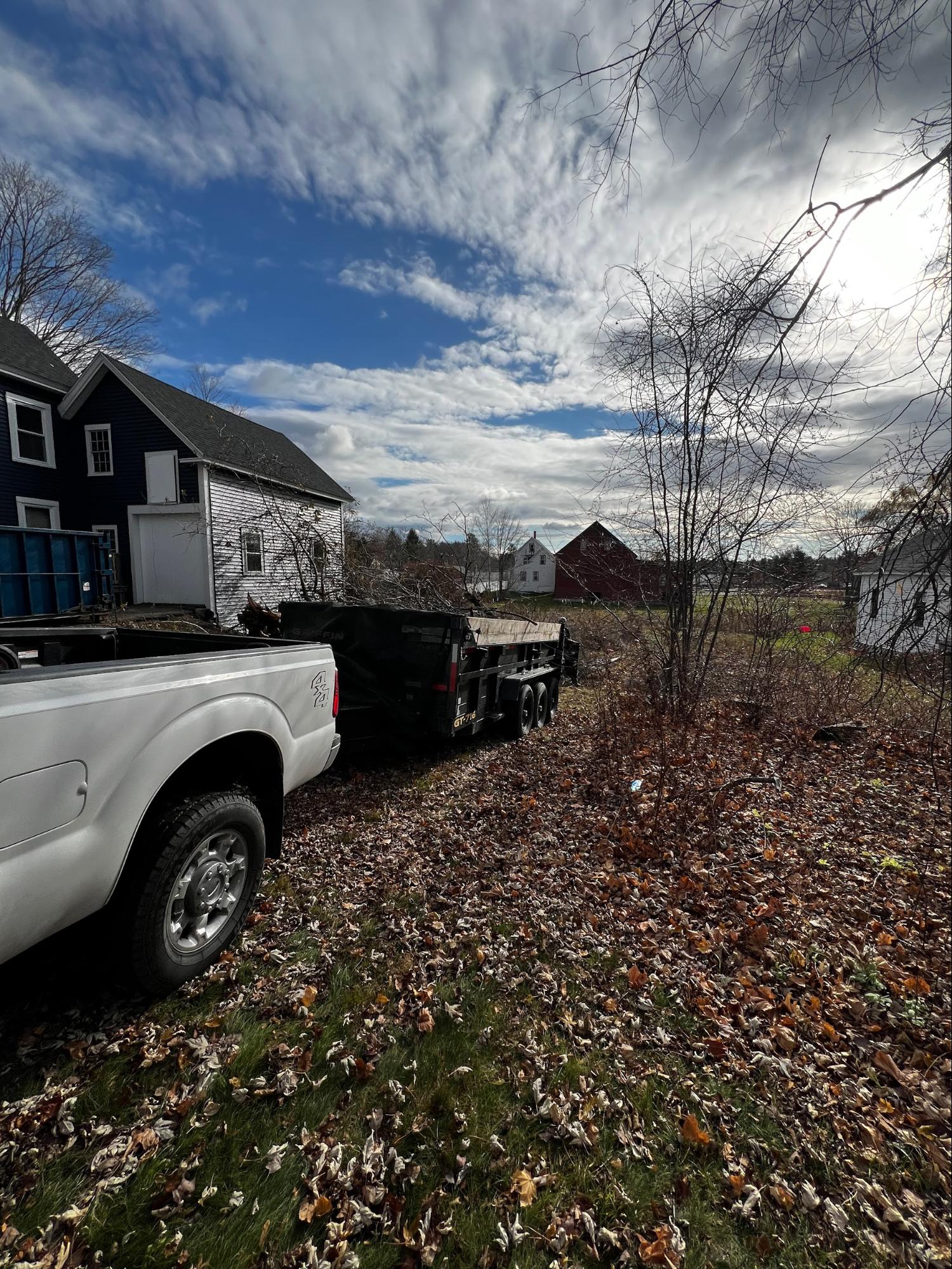 Truck and dump trailer on tree work job site